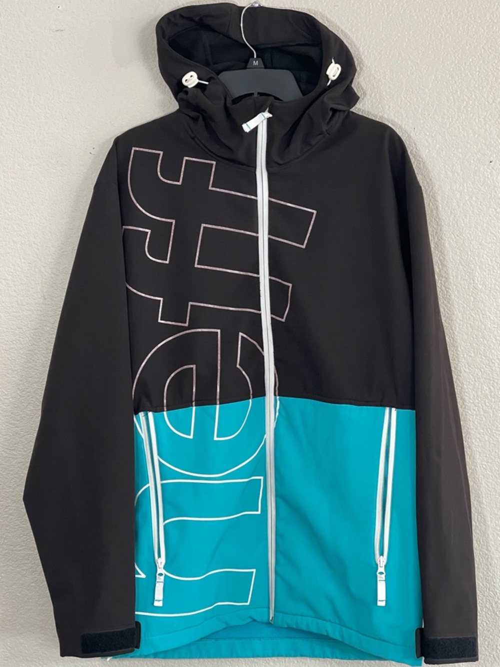 Neff Two-Tone Black and Teal Hooded Shell Snowboard Jacket with Bold Graphic